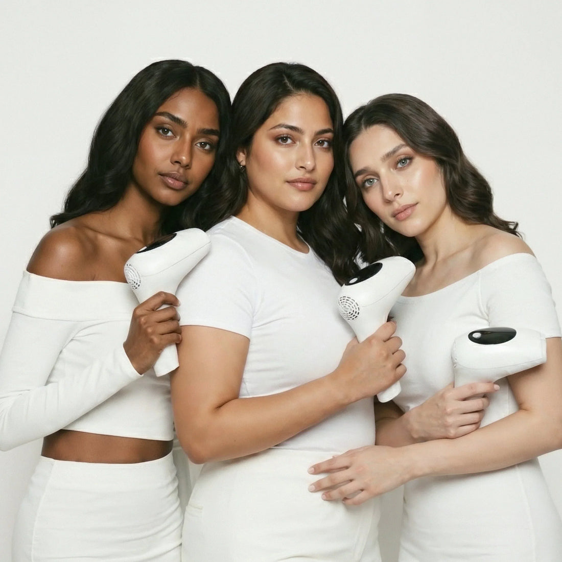 Three models with diverse South Asian skin tones holding GlowPro IPL handsets, demonstrating safe hair removal for different skin types