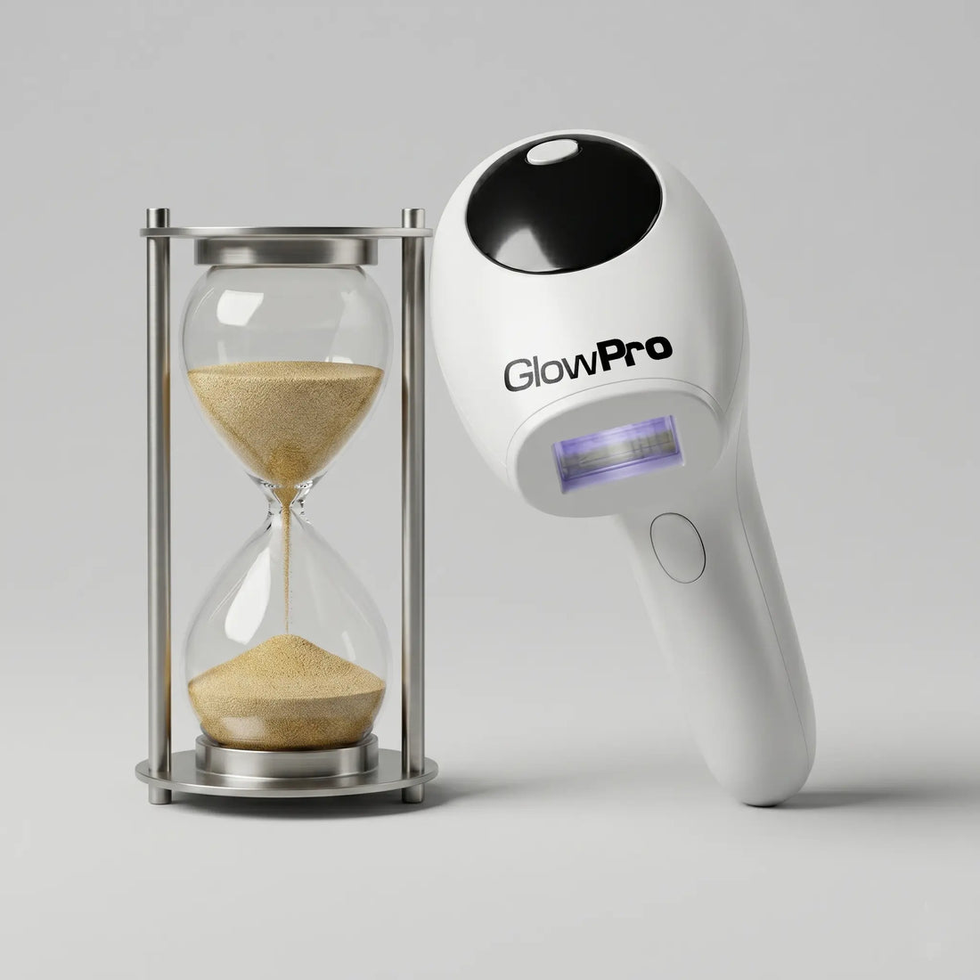 A white GlowPro IPL hair removal handset standing next to an hourglass, symbolizing fast full-body treatment times.