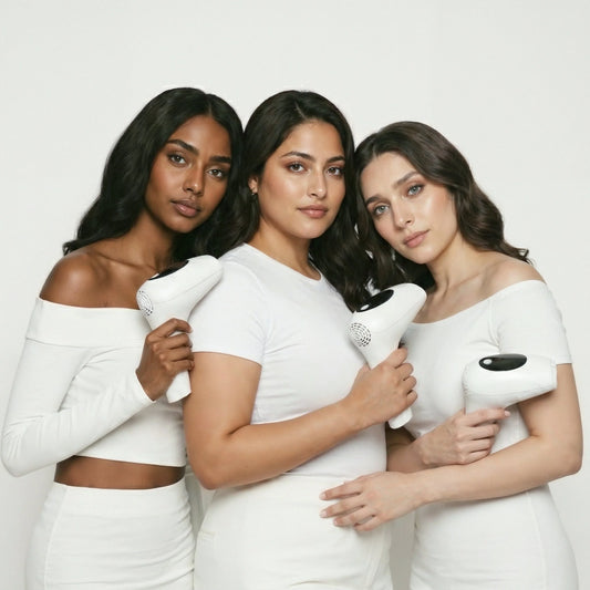 Three South Asian women with diverse skin tones holding GlowPro IPL+ at-home hair removal devices, showcasing safety and efficacy across the Pakistani skin tone spectrum
